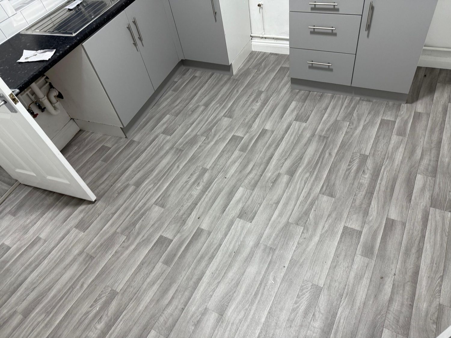 Grey plank LVT fitted in a kitchen
