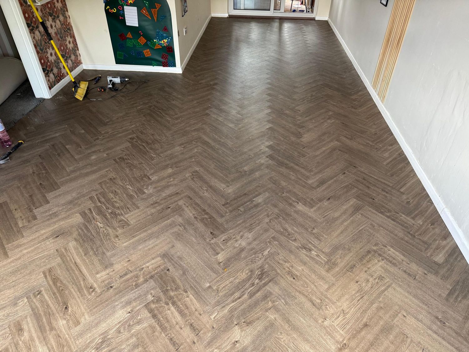 Herringbone LVT run through a large open room