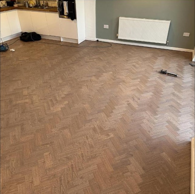 Herringbone floor through a kitchen diner